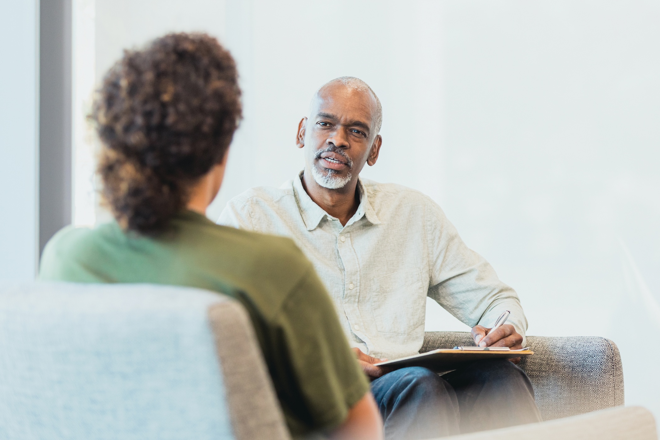 Older man interviewing a young female over a desk